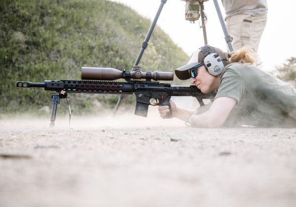 competitive shooting aiming rifle while in a prone position