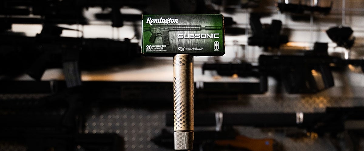 Remington Subsonic box balancing on the top of a suppressed rifle