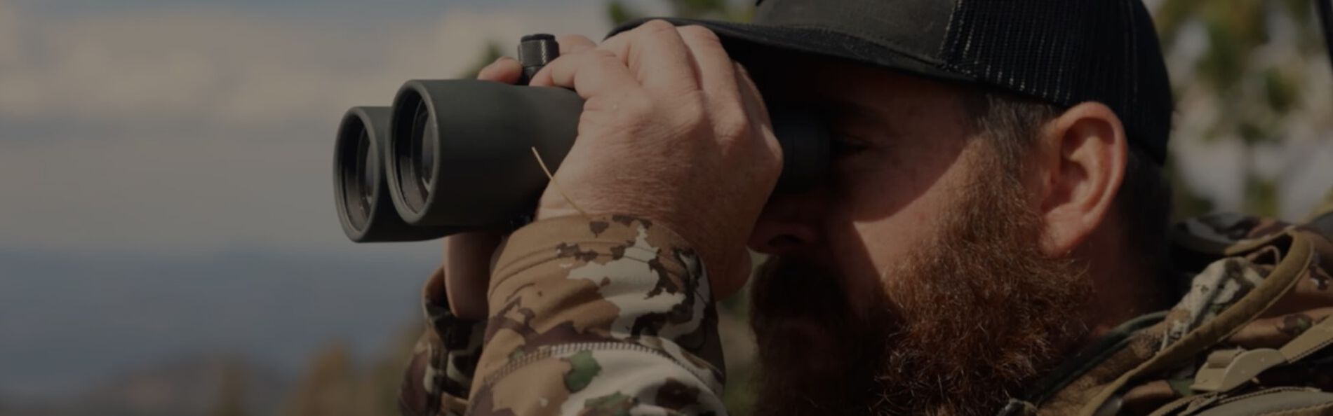 Ben Dettamanti looking through binoculars