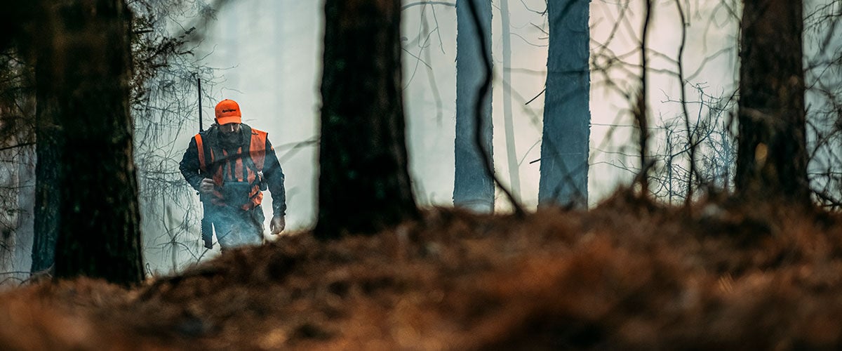 hunter walking through the trees