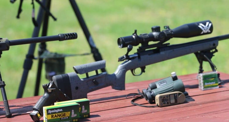 rifle on a bi-pod along Remington Range Clean boxes and binoculars