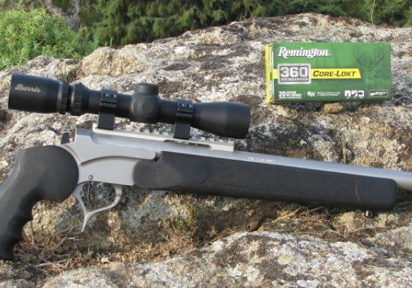 rifle laying against a rock with a box of Core-Lokt 360 Buckhammer