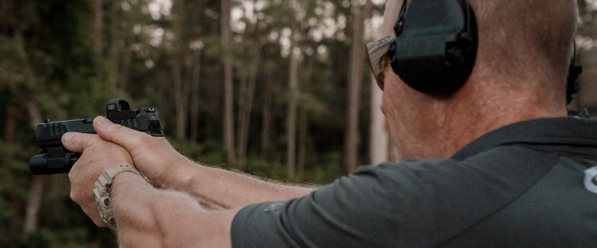 shooter aiming handgun
