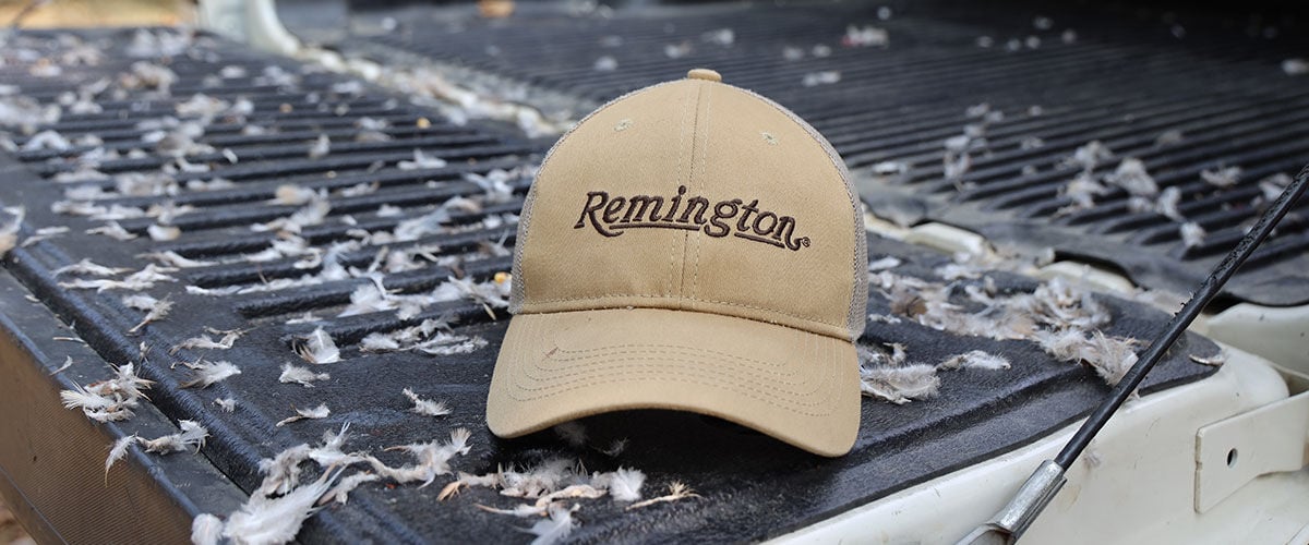 Remington hat on a tailgate with feathers everywhere