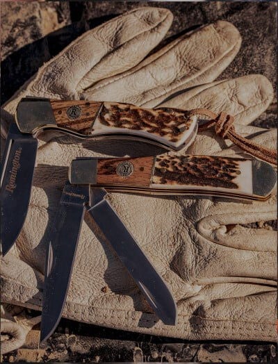Sportsman Knives laying on leather gloves