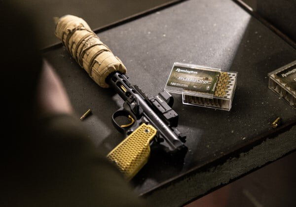 Subsonic box sitting next to a handgun on a table