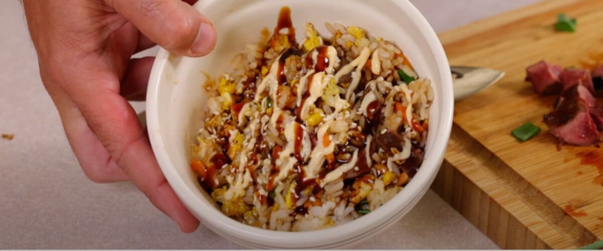 duck fried rice in a bowl with sauces