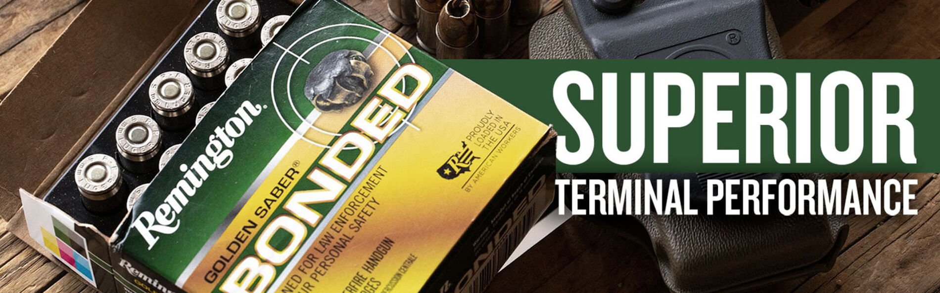 Golden Saber Bonded box with cartridges and a handgun with a green stripe and the words Superior Terminal Performance on it