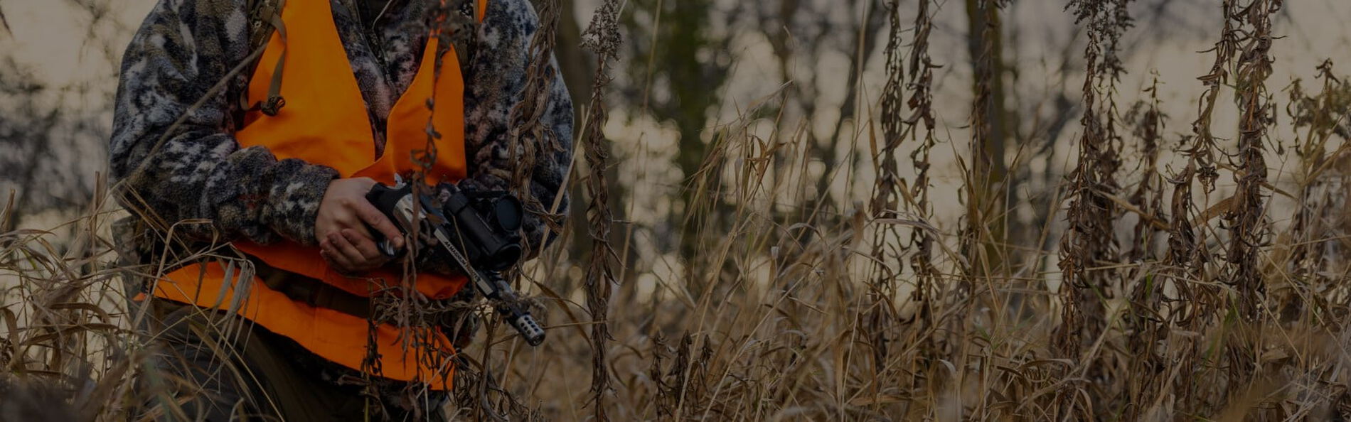 Hunter walking outside with a handgun