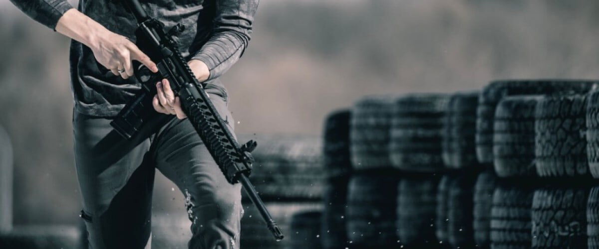 shooter holding a rifle while running outside