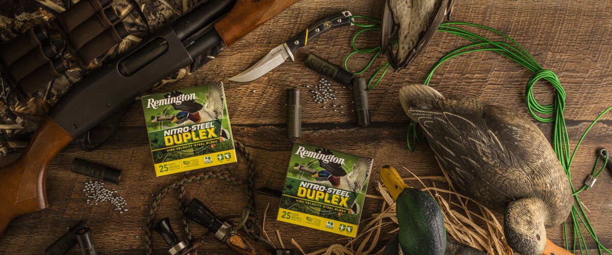 Nitro-Steel Duplex packaging, calls, decoys, shotgun, shotshell, and knives on a table