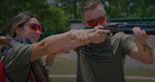 Julia Stallings giving tips and tricks to another shooter