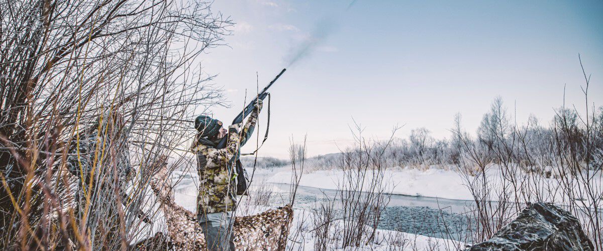 hunter aiming shogun outside in the snow