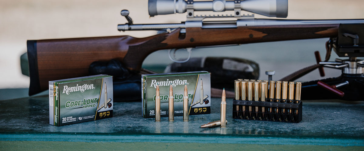 Core-Lokt Tipped boxes and cartridges in front of a rifle