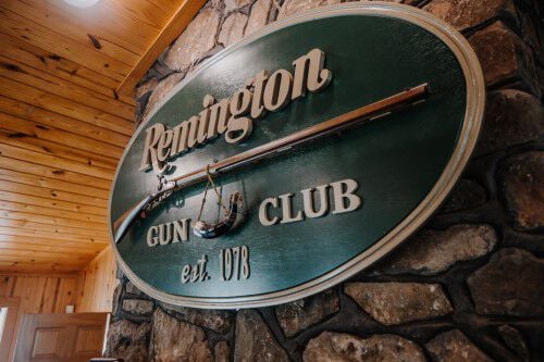 Remington Gun Club sign hanging on the wall in the Gun Club clubhouse
