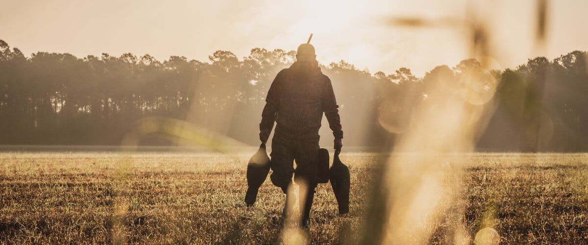 hunter carrying turkey decoys