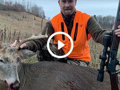 hunter standing by a dead deer