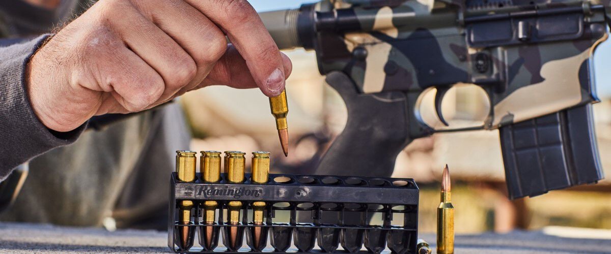 shooter taking Remington ammunition out of it's packaging