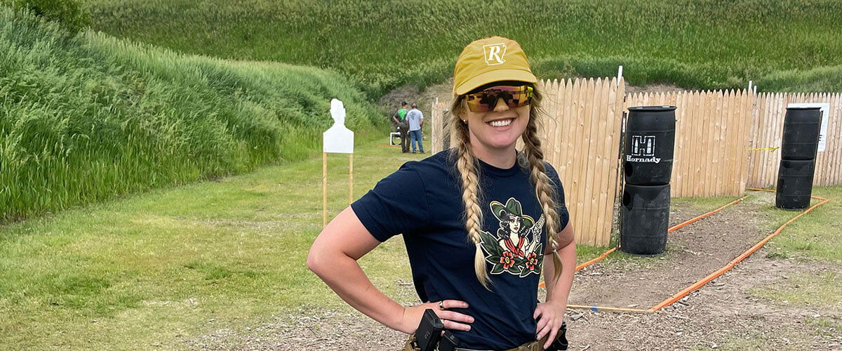 Audrey Mayes standing on a 3 gun course