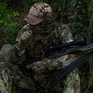 hunter in camo holding a rifle