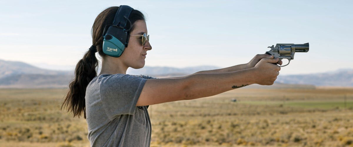 woman aiming handgun