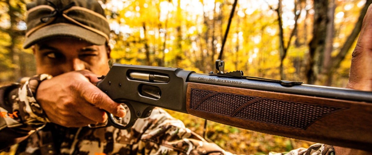 shooter aiming rifle with 360 Buckhammer