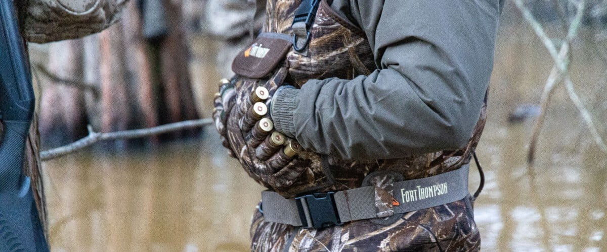 hunter wearing coveralls with shotshell pockets