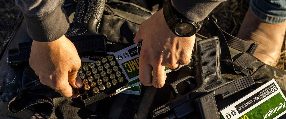 person removing cartridges from a UMC Handgun box