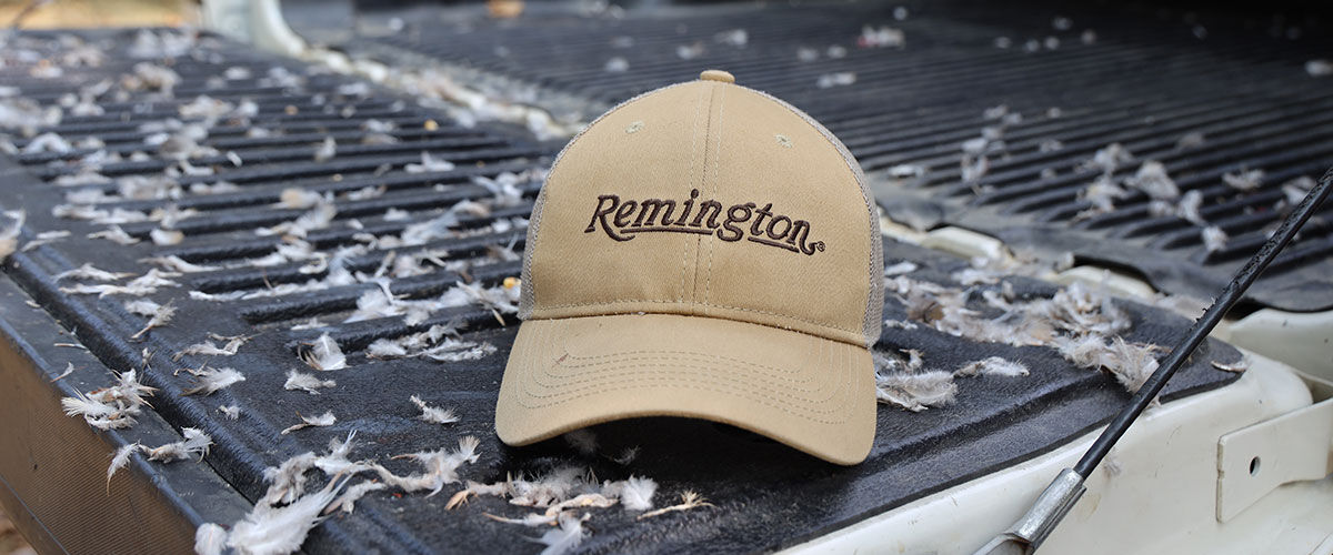 Remington hat on a tailgate with feathers everywhere
