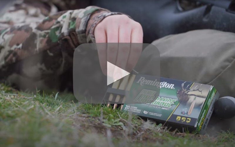 hunter reaching for Premier Long Range from packaging when laying on his back outside